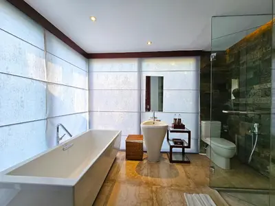 a bathroom with a tub and a toilet and a sink at Seminyak Icon - by Karaniya Experience - CHSE certified in Seminyak