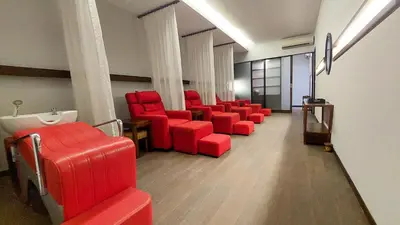 a waiting room with red chairs in a building at Seminyak Icon - by Karaniya Experience - CHSE certified in Seminyak