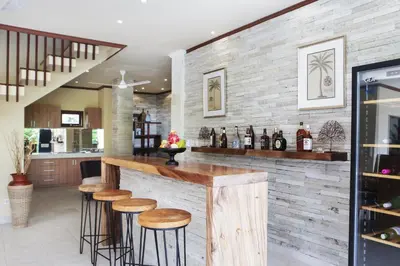 a bar in a kitchen with a brick wall at Villa Chambertin in Seminyak