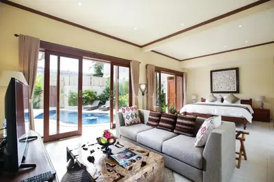 a living room with a couch and a bed at Villa Chambertin in Seminyak