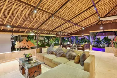 a large living room with a couch and a table at Villa Champagne in Seminyak