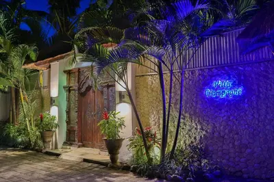 a house with a purple sign on the side of it at Villa Champagne in Seminyak