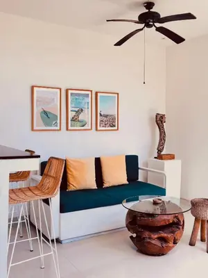 a living room with a couch and a table at La Belle Villa in Seminyak