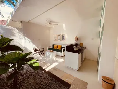 a living room with a couch and a table at La Belle Villa in Seminyak