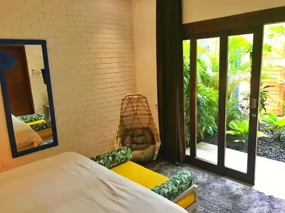 a bedroom with a bed and a mirror at La Belle Villa in Seminyak