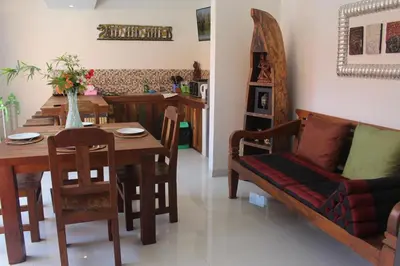 a living room with a table and a couch at Jukung Villas Kuta in Kuta