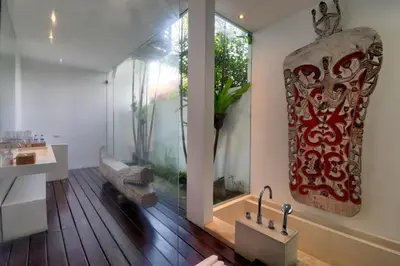 a living room with a large window and a sink at Beach Axis Villa, Seminyak in Seminyak