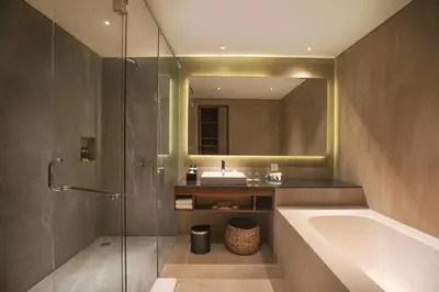 a bathroom with a tub and a sink and a mirror at Anja Jimbaran in Jimbaran