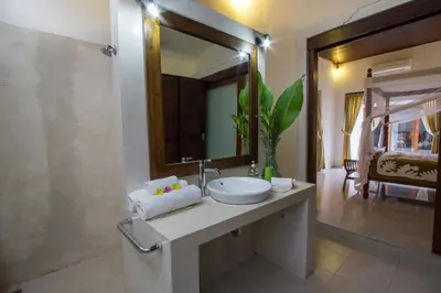 a bathroom with a sink and a mirror at Villa Kamboja Senior in Legian
