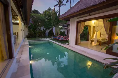 a swimming pool in the backyard of a house at Villa Kamboja Senior in Legian