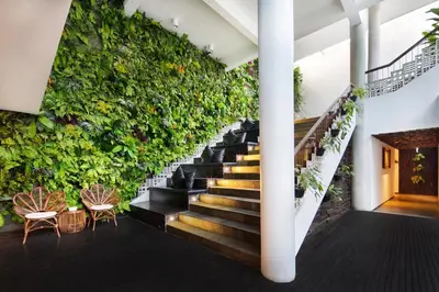 a staircase with a green wall of plants at The Akmani Legian in Legian