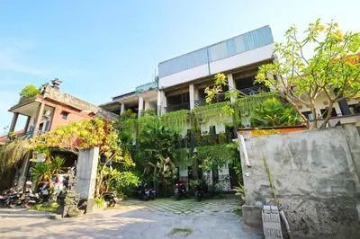 a building with a bunch of plants on it at Micost Homestay in Denpasar