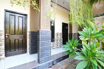 a front door of a house with plants at Micost Homestay in Denpasar