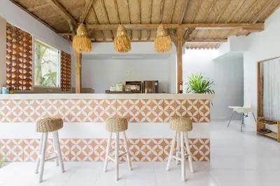a bar with two stools in front of a counter at Villa Orked 1 in Seminyak
