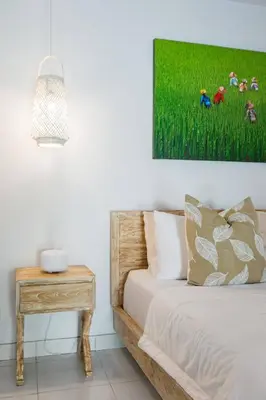 a bedroom with a bed and a painting on the wall at Villa Orked 1 in Seminyak