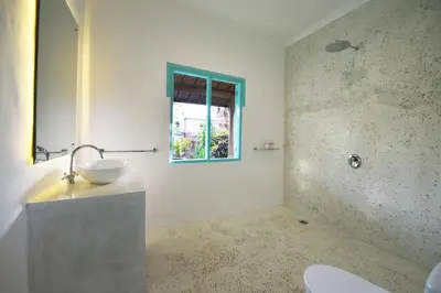 a bathroom with a sink and a window at Villa Zenta in Canggu