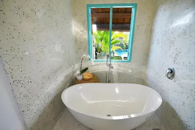 a white sink in a bathroom with a window at Villa Zenta in Canggu