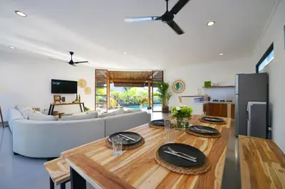a living room with a table and a couch at Villa Zenta in Canggu
