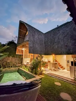 an external view of a house with a swimming pool at Villa Made West in Seminyak