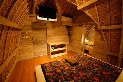 an overhead view of a room with a bed and a tv at Villa Made West in Seminyak