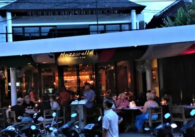 a restaurant with motorcycles parked in front of it at Villa Made West in Seminyak