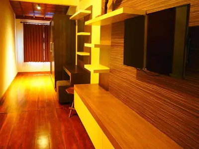 a living room with a flat screen tv on a wall at Juada Garden in Seminyak
