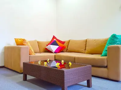 a living room with a couch and a coffee table at Juada Garden in Seminyak