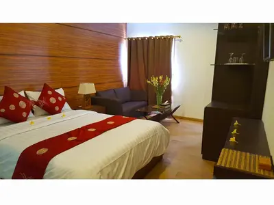 a hotel room with a bed and a chair at Juada Garden in Seminyak