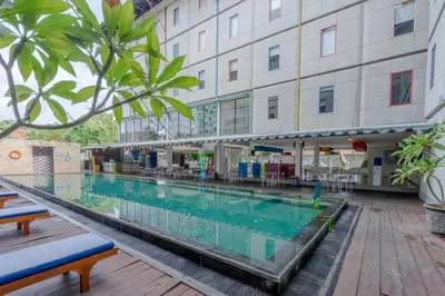 a large swimming pool in front of a building at POP! Hotel Kuta Beach in Kuta