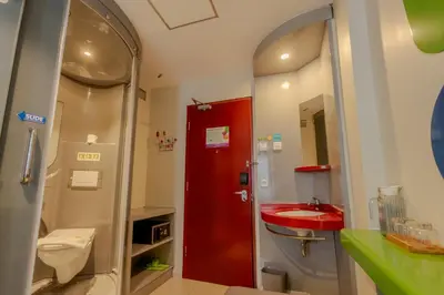 a bathroom with a red sink and a toilet at POP! Hotel Kuta Beach in Kuta