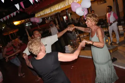 a group of people dancing at a party at Sarinande Hotel in Seminyak