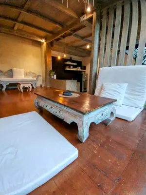 a living room with a coffee table and a couch at Villa Made East in Seminyak