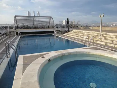 a large swimming pool on top of a building at Bali Paradise City Hotel in Denpasar