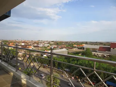 a view of a city from the balcony of a building at Bali Paradise City Hotel in Denpasar