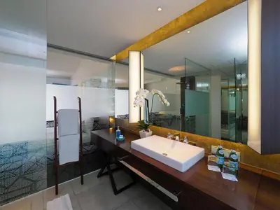 a bathroom with a sink and a large mirror at IZE Seminyak by LifestyleRetreats in Seminyak