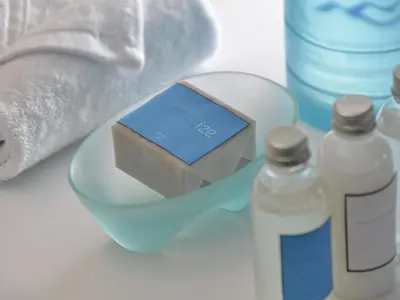 a box of soap and a bottle of water at IZE Seminyak by LifestyleRetreats in Seminyak