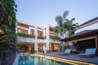 an exterior view of a house with a swimming pool at Villa Artisane in Seminyak