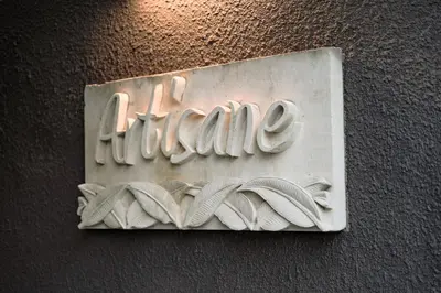 a sign for a library with books on a wall at Villa Artisane in Seminyak