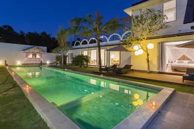 a swimming pool in the backyard of a house at Villa Hasian Jimbaran in Jimbaran