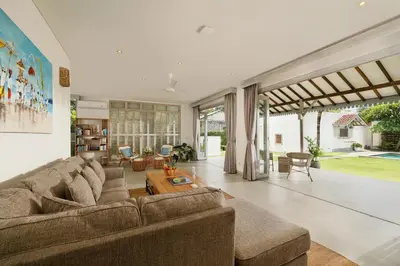 a living room with a couch and a table at Villa Hasian Jimbaran in Jimbaran