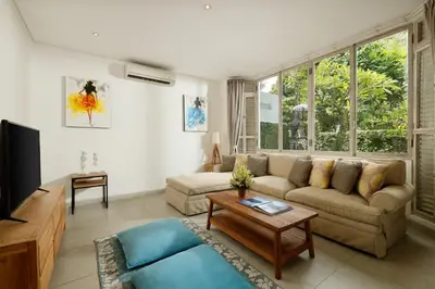 a living room with a couch and a table at Villa Hasian Jimbaran in Jimbaran