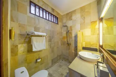 a bathroom with a sink and a toilet at Amandaru Villa by RPM in Legian