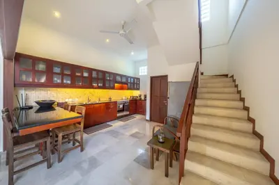 a kitchen with a staircase leading up to a kitchenasteryasteryasteryasteryasteryastery at Amandaru Villa by RPM in Legian
