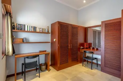a home office with a desk and two chairs at Amandaru Villa by RPM in Legian