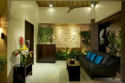 a living room with a couch and some plants at My Villas In Bali in Seminyak