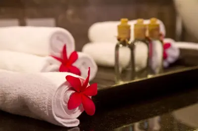 a towel with a red flower on top of a counter at My Villas In Bali in Seminyak