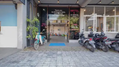 a group of motorcycles parked outside of a store at Beach Hut Hostel in Kuta