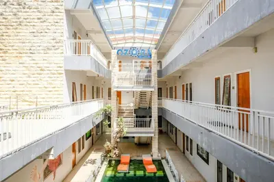 an empty hallway of a building with a skylight at RedDoorz Plus @ Mahendradatta Denpasar in Denpasar