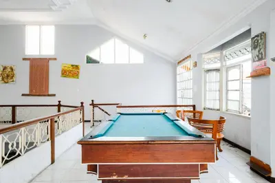 a pool table in the middle of a room at RedDoorz Plus @ Mahendradatta Denpasar in Denpasar