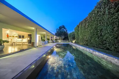 a swimming pool in the middle of a house at Casa Priya Petitenget in Seminyak